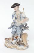 Meissen figure of a bagpiper modelled in blue and gilt with black hat, a dog and sheep at his feet