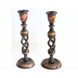 Pair of papier mache twisted column candlesticks with painted floral design, each 32cms high