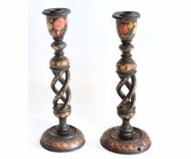 Pair of papier mache twisted column candlesticks with painted floral design, each 32cms high