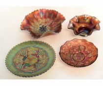 Group of four carnival glass dishes in iridescent orange, the largest 23cms diam