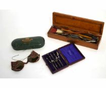 Pencil box containing vintage nibs etc, pair of vintage doggles, and small vintage cased