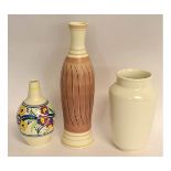 Collection of Poole ware vases, including one with floral sprays, another free-form vase with a