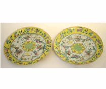 Pair of Chinese porcelain plates decorated in famille rose enamels, with courtiers, dogs and