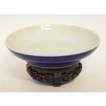 Chinese circular shallow bowl with dark blue glazed underside, five character mark under, carved
