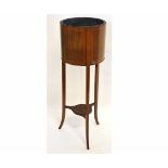 Edwardian mahogany circular planter with open top, fitted with a toleware inner, supported on