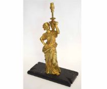 Lamp modelled as a classical maiden, with gilt metal finish on a wooden base, 30cms high