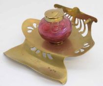 Art Nouveau brass stylised and pierced inkwell with cranberry well and brass lid, stamped