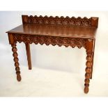 19th century oak hall table with carved floral front with repeating decoration and bobbin turned