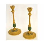 Pair of treen or toleware candlesticks, the wooden body with a green and orange design, 32cms