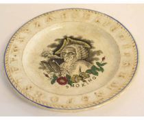 Mid-19th century children's alphabet plate, the centre with an 18th century gentleman with pipe