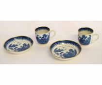 Pair of Caughley cups and saucers, circa 1790, decorated with prints in underglaze blue, with gilt