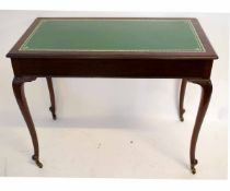Early 20th century mahogany two-drawer writing table with gilt tooled green inset and cabriole legs,