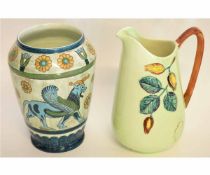 Carlton ware jug with brown handle and moulded design of leaves and berries on a green ground,