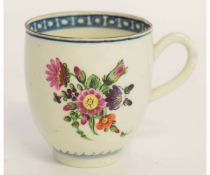 Worcester cup decorated in polychrome with floral sprays, the interior with a blue cell border and