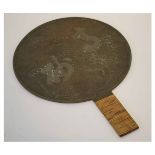Late 19th/early 20th century polished bronze hand mirror, the back with grain beneath a prunus tree,