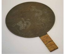 Late 19th/early 20th century polished bronze hand mirror, the back with grain beneath a prunus tree,