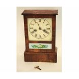 Mantel clock with wooden case, the front with an inset panel and floral sprays, 30cms high