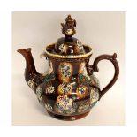 Large barge-ware teapot and domed cover decorated in typical fashion with floral sprays on a brown