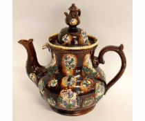 Large barge-ware teapot and domed cover decorated in typical fashion with floral sprays on a brown