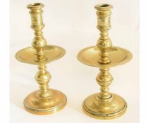 Pair of 17th century style brass candlesticks with circular foot with knopped column with drip tray,