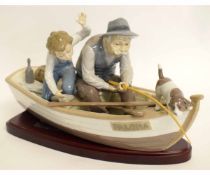 Large Lladro figure of an elderly man and a boy in a boat, fishing with a dog in the prow