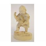 Late 19th/early 20th century Oriental carved ivory Okimono of a young child holding a cockerel,