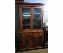 Edwardian walnut bookcase, the top fitted with two glazed doors with adjustable shelf over two