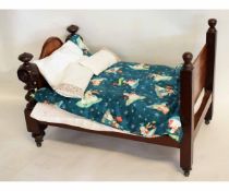 Victorian mahogany doll's bedstead with decorative footboard, 62cms long