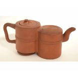 Oriental terracotta double tea pot with looped handle, ribbon tie decoration to the body, animal