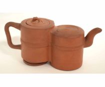 Oriental terracotta double tea pot with looped handle, ribbon tie decoration to the body, animal