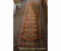 Caucasian wool runner, triple gulled border, central panelled lozenges, mainly rust field, 93 x