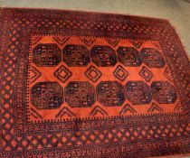 Good quality Bokhara type carpet in a rust field with repeating lozenge centre on a multi-gulled