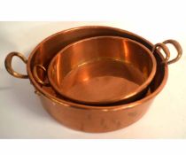 Graduated set of two Victorian copper two-handled pans (2)