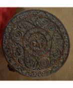 Eastern hardwood carved circular table with decorative carved top supported on three elephant carved