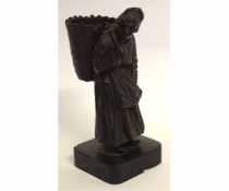 Bronze figure of an old lady with a basket on her back, 16cms high