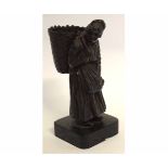 Bronze figure of an old lady with a basket on her back, 16cms high