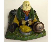 Model of a toper in green and brown glazes