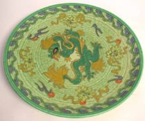 Green ground dragon pattern charger by Charlotte Rheid, 37cms diam (a/f)