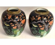 Pair of Chinese ginger jars (lids missing), decorated with perched birds amidst foliage on a noir