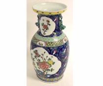 Late 20th century Oriental polychrome baluster vase decorated with reserve panels of flowering