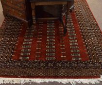 Good quality modern Bokhara carpet with rust ground with multi-gulled border, 190cms wide x 290cms