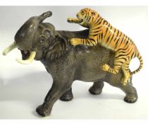 Large model of an elephant being attacked by a tiger, 33cms long
