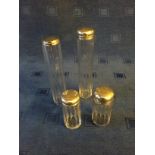 Set of 4 glass ladies vanity bottles with hallmarked silver tops