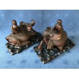 Pair of Chinese carved wood buffalos with riders aloft, on hardwood stands, 21cmH