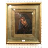 A gilt framed oil painting portrait of a North African boy in traditional attire, 24x19cm