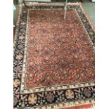 Persian style carpet rust ground with stylized floral decoration