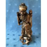 Chinese carved wood figure of an elderly fisherman carrying a vessel, 44cmH