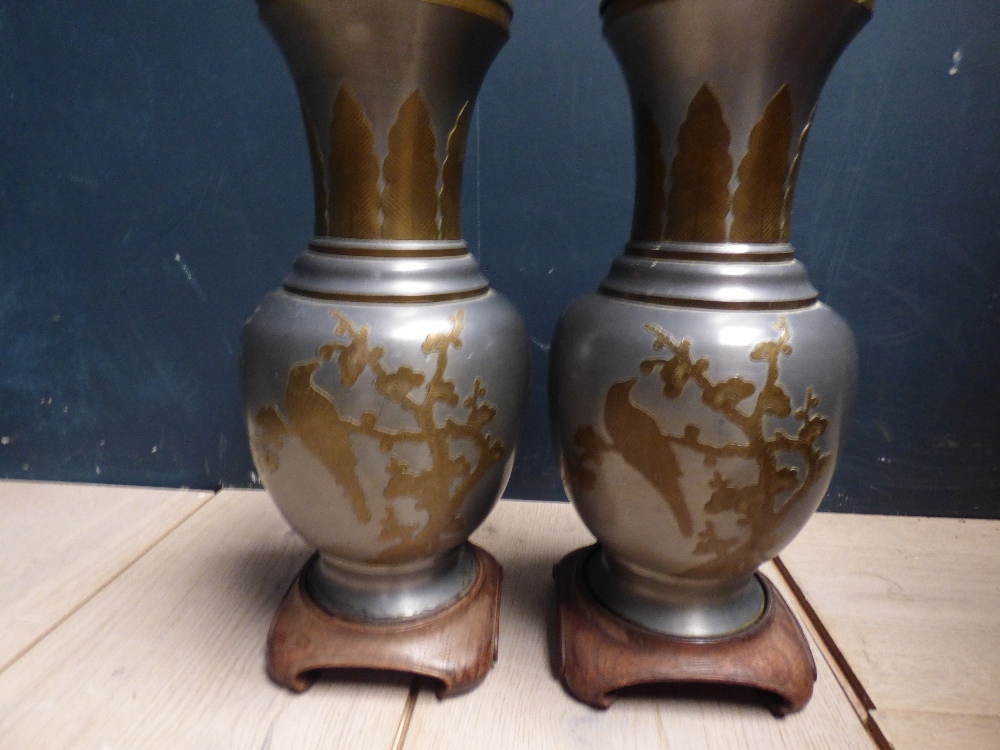 Pair Chinese tin and brass table lamps with floral and bird decoration on wooden stands
