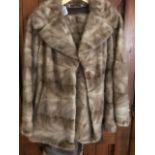 Fur coat, light tan colour with a hidden zip to add or remove a longer length as required, approx.