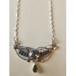 Silver and enamel necklace with peridot drop, in the Art Nouveau style